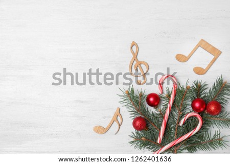 Composition with decorative music notes and space for text on wooden background, top view
