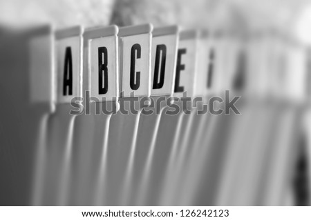 Alphabetical filing tray office index organizer. Selective focus black and white. Royalty-Free Stock Photo #126242123