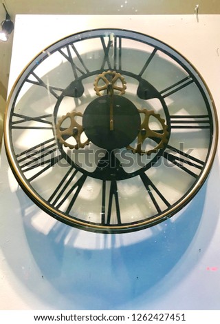 Decorative wall clock big size hanging on white wall.