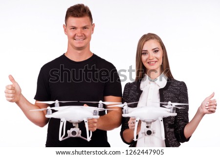 Boy and girl are holding flying drones and money, smiling