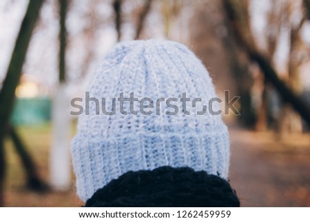 Warm knitted wool women's hat on the head in blue