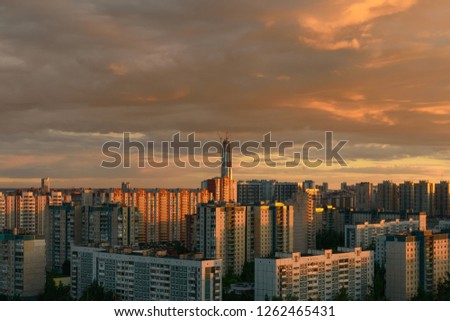 Sunset view of stone jungle of lots of multi-flat houses and a skyscrapper under construction in Saint-Petersburg, Russia