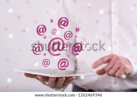 E-mail concept above a tablet held by a man in background