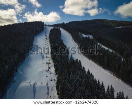 Beautiful aerial drone photo on winter park in cold season.Snowy landscape of Carpathian mountains in Europe.Travel destination for active holiday tourism