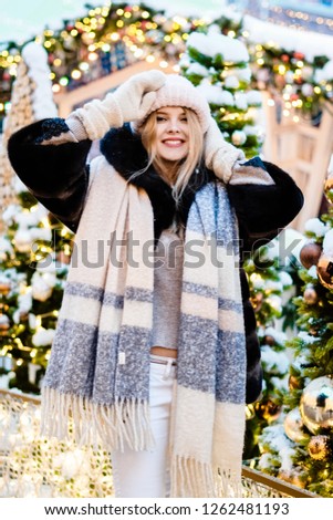 Christmas picture of a cute blonde girl on the Christmas market