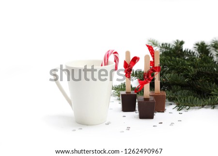 Christmas and New Year ornament of hot chocolate on a stick and a Christmas tree on white background.