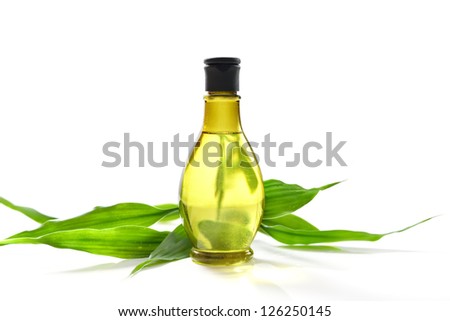 Spa treatment with bottle and green bamboo isolated on white