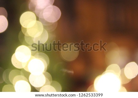 Blurred golden garland on Christmas tree, defocused background