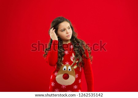 Happy winter holidays. Small upset girl. New year party. Santa claus kid. Little girl child in santa red hat. Present for Xmas. Childhood. Christmas shopping. red background.