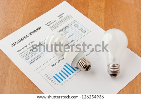 Energy efficient and incandescent  bulbs on electric bill. Energy efficient house concept.