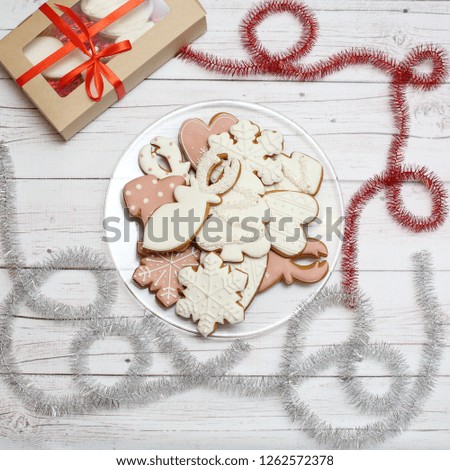 Christmas gingerbread cookies on light wooden background