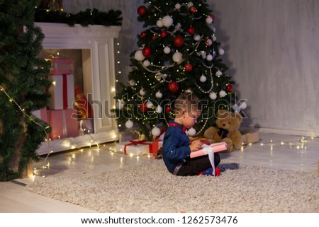 boy open up gifts from Christmas New Year holiday house