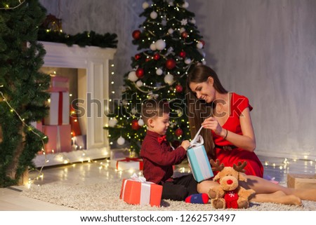 mother and son open up gifts from Christmas New Year holiday house