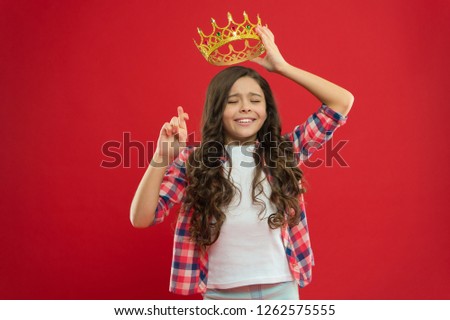 Hope for the best. Kid hold golden crown symbol of princess. Childhood concept. Every girl dreaming to become princess. Girl cute baby hold crown while stand red background. Lady little princess.