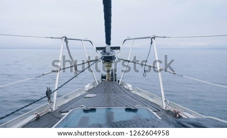Man making photo of landscape during sea voyage on sailing ship back view