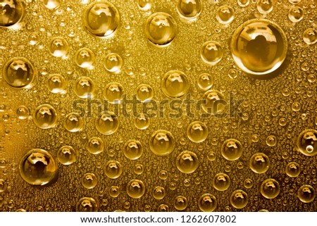 Water Drops On Gold Background, Close Up.