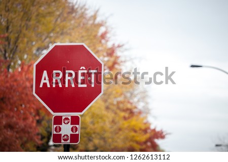 Quebec Stop Sign, obeying by bilingual rules of the province imposing the use of French language on roadsigns, thus translated Stop into Arret, taken in the streets of Montreal, Canada

