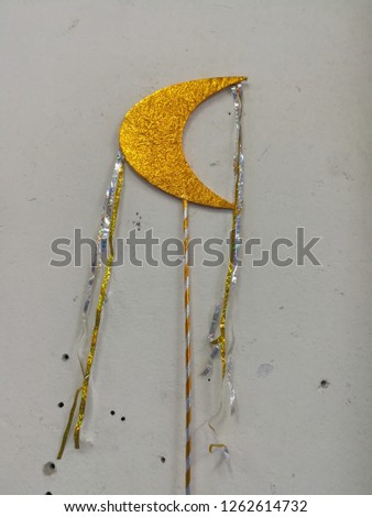 Yellow Crescent moon and a ribbon tail on a white background.
It in the parade of student athletes.