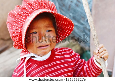 Native american toddler girl crying outdoor.