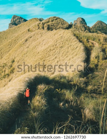 wanderlust and travel concept. traveler-backpacker on the way to the top of mountains, amazing view. Man hiking. atmospheric moment