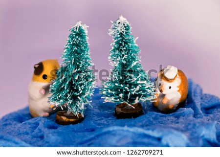 Prepare pine trees for Christmas decorations with miniature and slime snow.