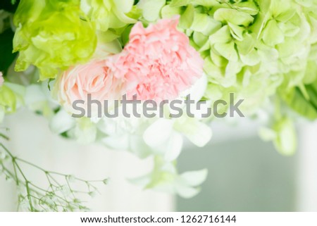 Selective focus close up of beautiful pastel branches pink rose and green peony flowers decorations in wedding ceremony in church with copy space for text or message