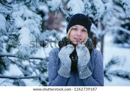 happy young woman in winter park for a walk in nature