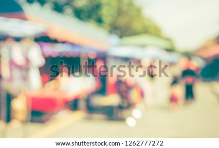 Vintage tone abstract blur image of Day market  on street with bokeh for background usage .