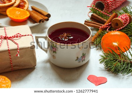 Mulled wine with spices and gifts on the table.  