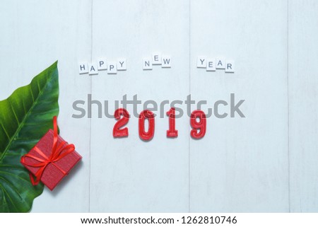 Happy New Year's layout. numbers 2019 notepad and free space for text. Christmas decorations and goals for the new year on the wooden background