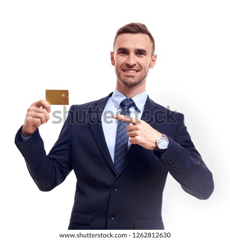 Happy smiling young man showing credit card isolated on white background.