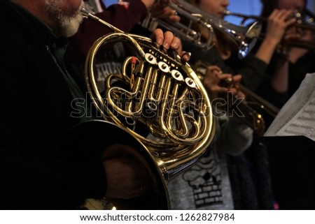 Christmas concert in the school. Musical brass instruments, Adults and Children. Dark Background.