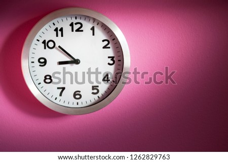 
wall clock on pink background