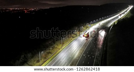 A deliberately blurred anisotropic image of the traffic on the M62 viewed from the Scammonden Bridge before sunrise