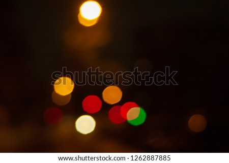 Blurred night background of city street road with bokeh effect. Abstract wallpaper for design and editing images.