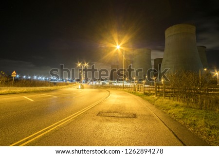 Pavement and power station at night