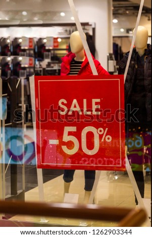 the inscription "sale" in the window of a clothing store