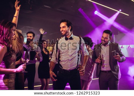 Cheerful friends partying in a nightclub