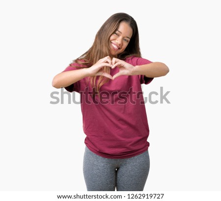 Young beautiful brunette woman over isolated background smiling in love showing heart symbol and shape with hands. Romantic concept.