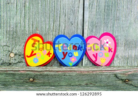 Colorful hearts on wooden background