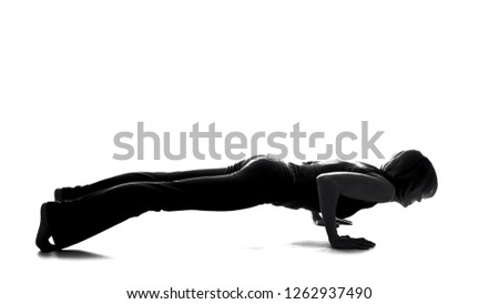Sport female shadow practicing plank exercise, body strength, pilates training