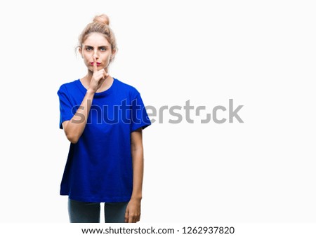 Young beautiful blonde and blue eyes woman wearing blue t-shirt over isolated background asking to be quiet with finger on lips. Silence and secret concept.