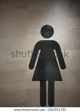 Women toilet symbol black and white /  Woman’s restroom sign affixed to door in office building   