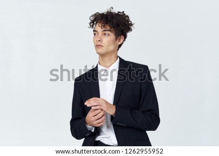 Business man in a black jacket on a gray background                     