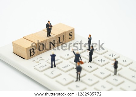 Miniature people Businessmen waiting for earnings Profits of the business To pay a bonus. using as background business concept and finance concept with copy space  for your text or  design.