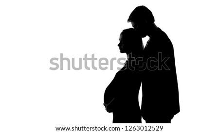 Silhouette of young male kissing sad pregnant woman, unhappy relationship