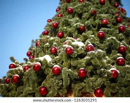 new year tree decorated with red balls and snow