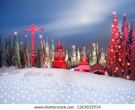 At the top of the mountain in the Carpathians, Ukraine is a wooden old Christian monastery. Christmas fabulous picture as a fantasy artist, night shooting