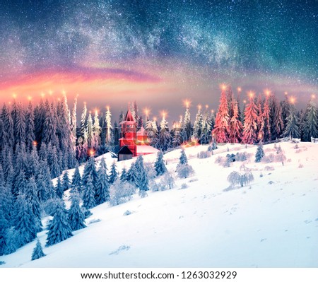 At the top of the mountain in the Carpathians, Ukraine is a wooden old Christian monastery. Christmas fabulous picture as a fantasy artist, night shooting