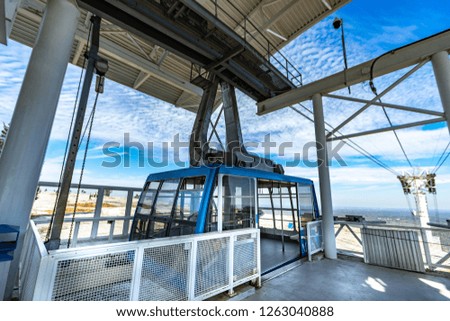 A gondola lift / cable car are waiting for passenger  at boarding platform 